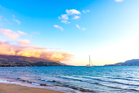 Sunset during summer on the island of Ilhabela with the sea and mountains aroundの写真素材