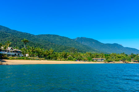 Feiticeira Beach surrounded by forests and the sea on the island of Ilhabela on the north coast of Sao Pauloの写真素材