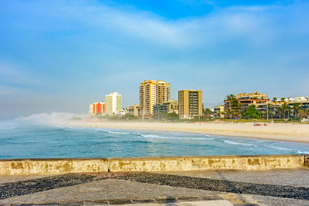 Morning on the breakwater of Barra da Tijuca beach, one of the most famous in the city of Rio de Janeiro with its buildings facing the seaの写真素材