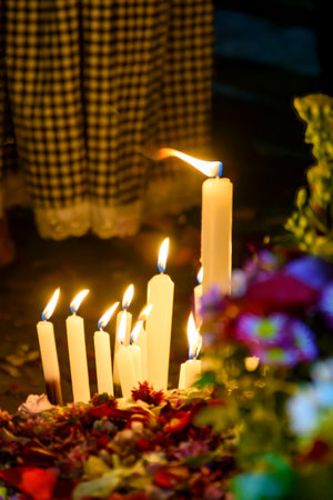 Candles and flowers placed as an offering to the religious entity of Umbandaの写真素材