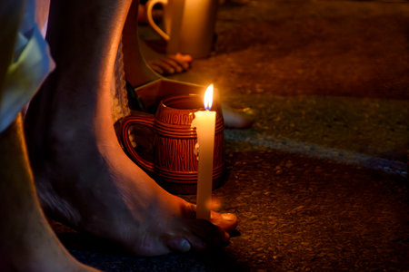 Bare feet holding a candle during prayer in a typical Umbanda ceremonyの写真素材