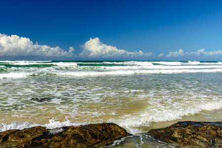Small waves on a deserted and rocky beach in Serra Grande on the southern coast of the state of Bahiaの写真素材