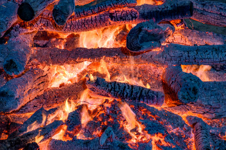 Embers burning in a bonfire during a festival in honor of Saint John in Brazilの写真素材