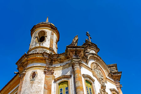 Facade and tower of a historic baroque church in the city of Ouro Preto in Minas Geraisの写真素材