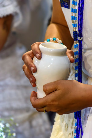 Woman holding an offering to Yemanja during an Umbanda ritual in Brazil