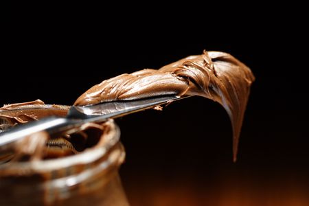 chocolate spread on a knifeの写真素材