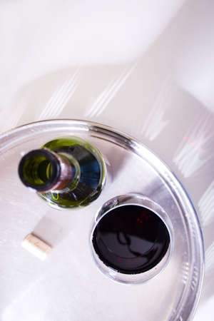 a glass of red wine, a bottle and corkの写真素材