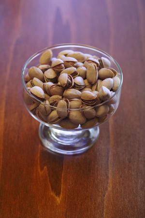 bowl with pistachios on a tableの写真素材