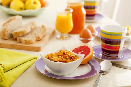 Breakfast with juice, fruits, jam and eggs