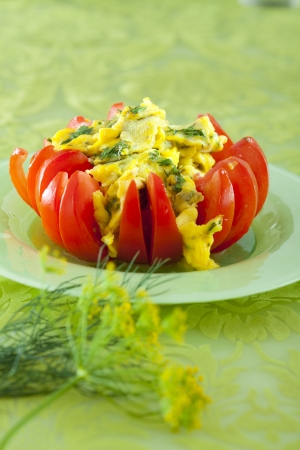 scrambled eggs in tomato with dill and milkの写真素材