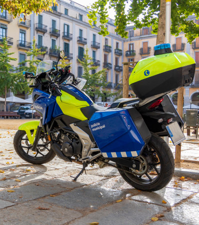 Police motorcycle parked in a square in the Catalan city of Girona in broad daylightの写真素材