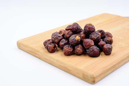Dried dates on a chopping boardの写真素材