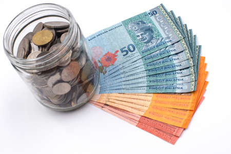 jar of coins and money in white background