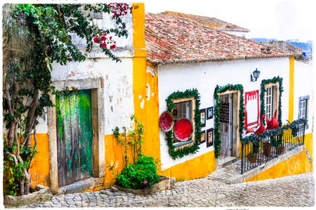 colorful streets of old town Obidos, touristic attraction of Portugalの写真素材