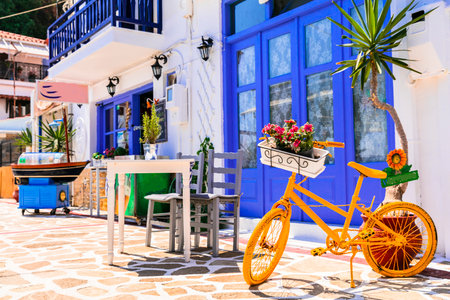 Greece street taverns decorated with flowers and old bicycle.のeditorial素材