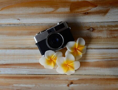 Vintage old camera with flower on the woodenの写真素材