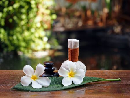 Spa massage compress balls, herbal ball and rock spa with flower, Thailandの写真素材