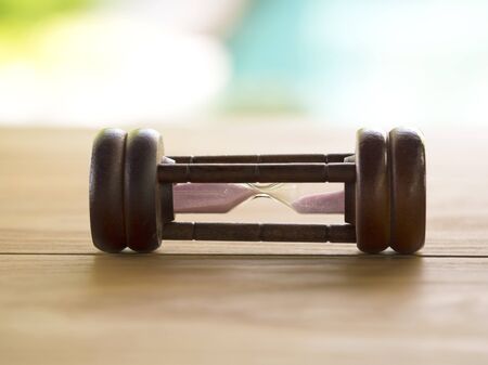 Hourglass on blurred natural backgroundの写真素材