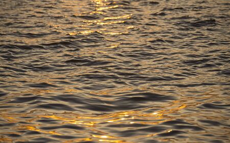 Background photo, sun glare on dark sea water with wave pattern, select focusの写真素材