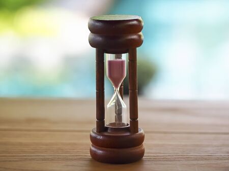 Hourglass on blurred natural background, select focusの写真素材