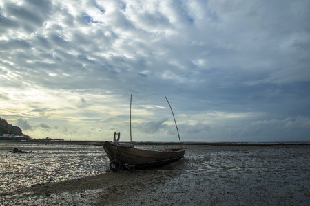 Twilight and sunset at the sea with fishing boat and cargo shipの写真素材