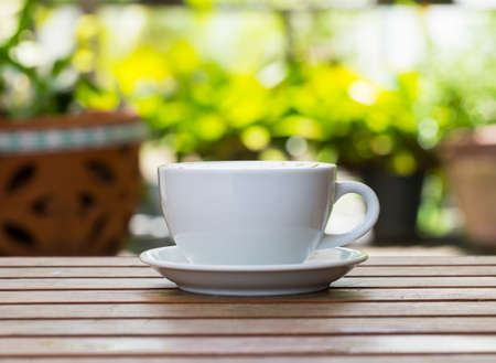 Coffee cup on wooden table ,soft focus