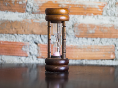 Closeup wooden hourglass ,stone background