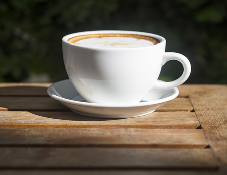 Coffee cup on wooden table ,soft focusの写真素材