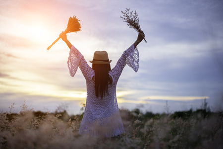 Woman in meadow. travel and sunset, soft and select focusの写真素材