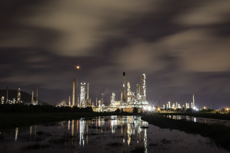 Oil refinery plant at sunrise with sky background
