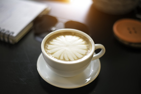 Beautiful woman with a cup of coffee at a cafeの写真素材