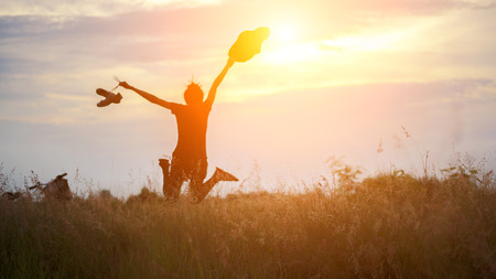 Young woman in meadow. travel and sunset, soft and select focusの写真素材