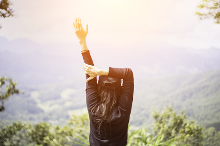 Woman feeling victorious facing on the mountain, Thailandの写真素材