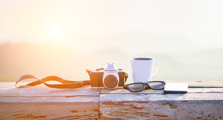 Cup with tea on table over mountains landscape with sunlight. Beauty nature backgroundの写真素材