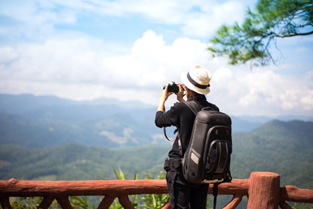 Hiker young woman feeling victorious facing on the mountain, Thailandの写真素材