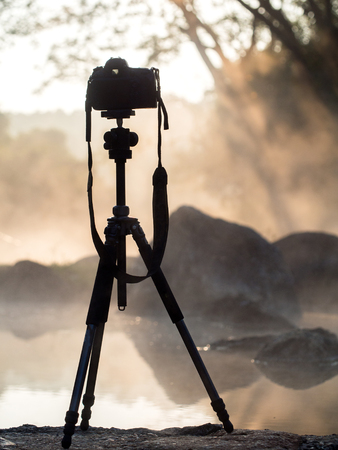 Silhouette of DSLR camera with sea at sunrise in the hot spring, Photo at morning time conceptの写真素材