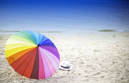 Beach umbrella on a sunny day, sea in backgroundの写真素材