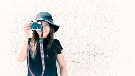 Asian butiful woman with camera. Hipster fashion photographer, vintage tone.の写真素材