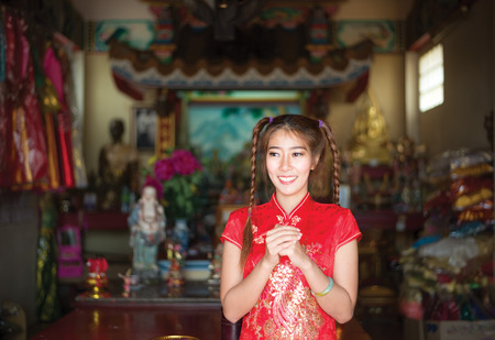 Chinese woman in traditional cheongsam in the new year in the Shrineの写真素材