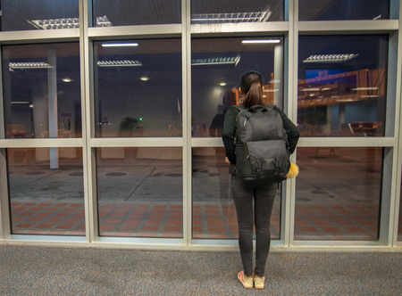 Traveler woman at the airport windowの写真素材