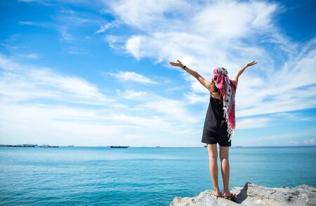 Traveler young women seeing the beautiful beach and blue sky, so happy and relaxの写真素材
