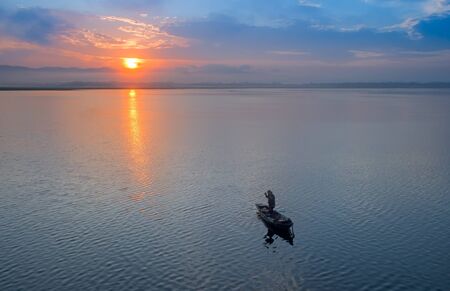 Fisherman of Bangpra Lake in action when fishing, Thailandの写真素材