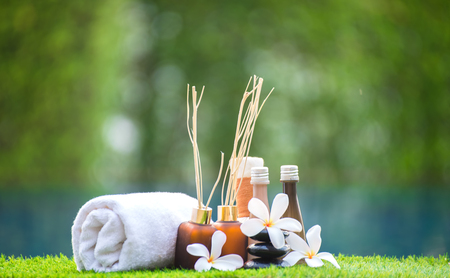 Spa treatment and product for hand and foot spa with flowers and water, wooden background; select and soft focus; Spa herbal compressing ball , white frangipani flowers, Thailand. Greenery tone 2017の写真素材