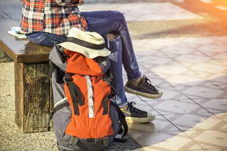 Traveler women wearing backpack holding map, waiting for a train.の写真素材