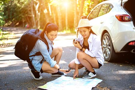 Group of beautiful young women walking in the forest, enjoying vacation, travel conceptの写真素材