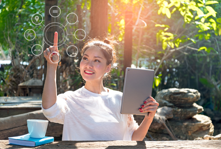 Women using laptop payments online shopping and icon customer network connection on screen, in the nature parkの写真素材