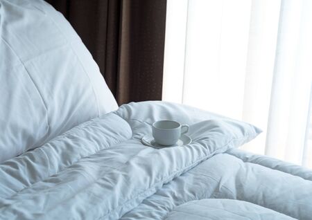 Fresh morning coffee on the bed.の写真素材