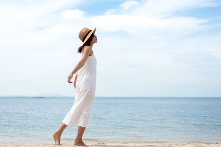Young women jumping and happy on the beach. Travel and Vacation. Freedom Conceptの写真素材