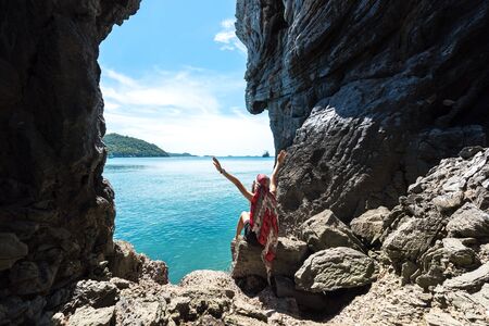 Travel women so ralax and happy in a cave near the sea in Keo Sichang, Thailandの写真素材