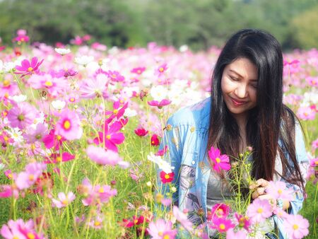 Beautiful girl in field of cosmos, so happy and relax, select focusの写真素材